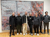 Six of fifteen artists with works on display at USF CAM spoke on a recent panel discussion with the exhibit curator. They'e standing in front of a piece by Angel Otero called "Look out your Window." From left to right: Miguel Luciano, Karlo Andrei Ibarra, Angel Otero, Gisela Col&oacute;n, Christian Viveros-Faun&eacute;, Jos&eacute; Lerma, Eddy Lopez. - Jessica Meszaros / WUSF