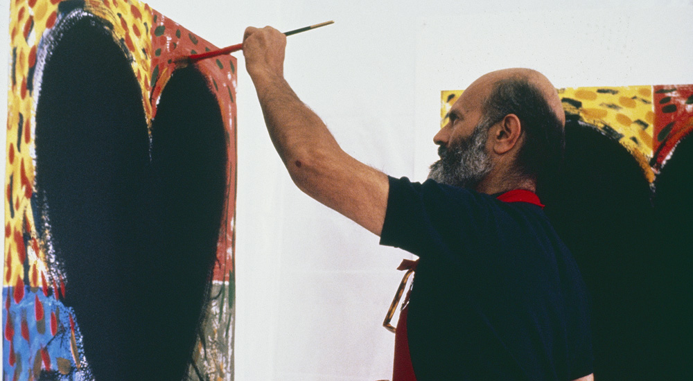 Jim Dine painting on an image of a blakc heart on the wall